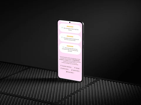 Telefoon met het roze reactie- en locatiegedeelte van de Taloor Bakery-website.