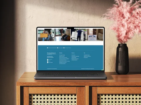 Laptop naast een vaas met werkfoto’s en de blauwe footer van Woningopfrisser.